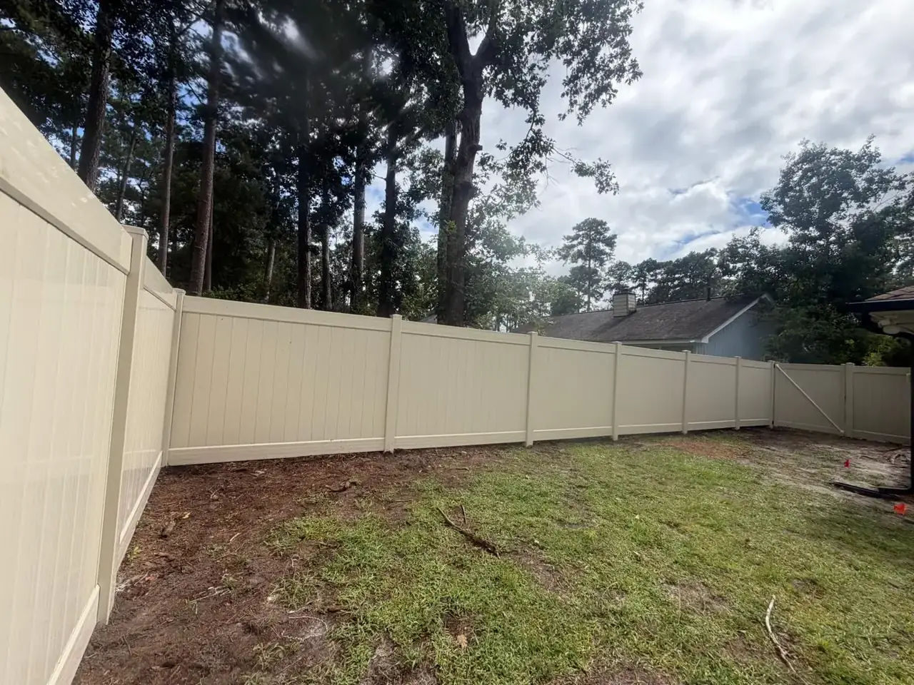 Tan vinyl privacy fence