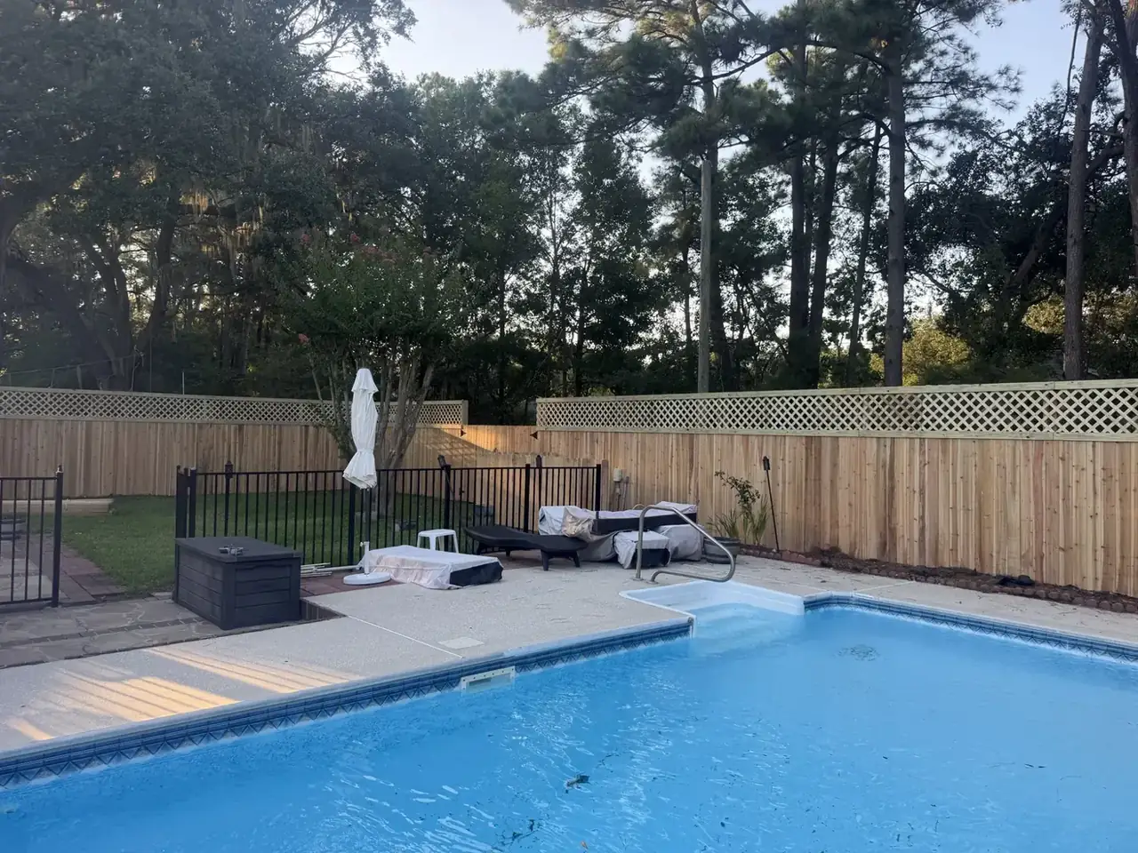 Wood privacy fence with lattice around a pool