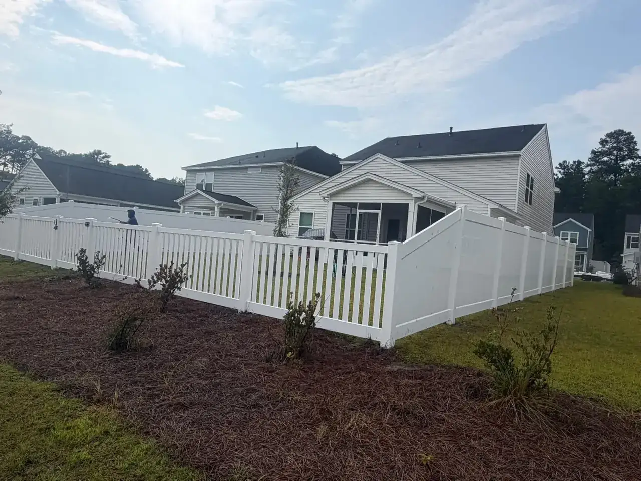 White vinyl flat-top picket fence